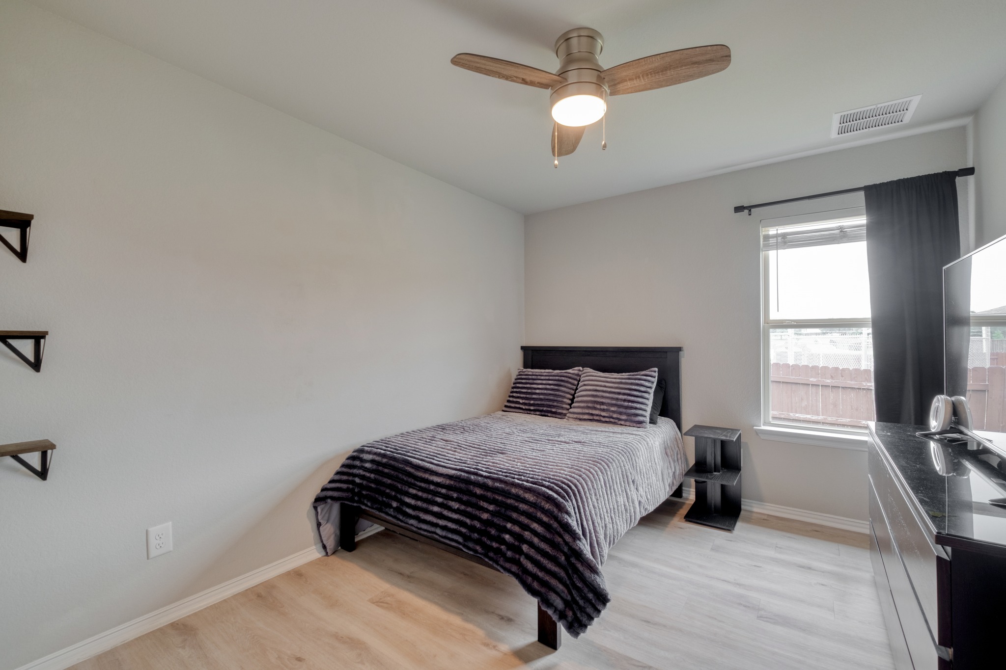 1000 Bright Star Cove Georgetown, TX 78628 - Photo 27 of 40 a bedroom with a bed a window and a chandelier