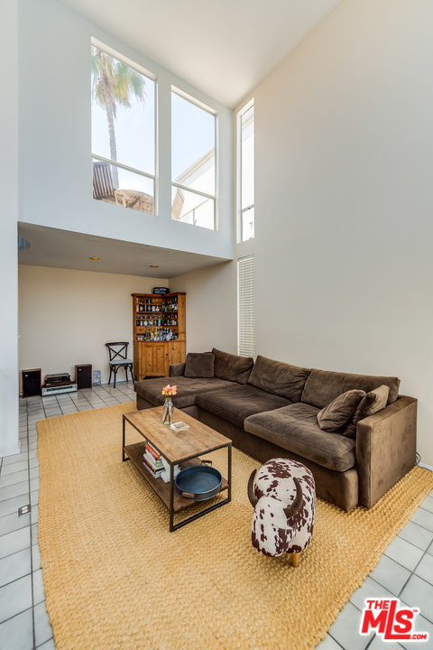 114 Fleet Street Marina del Rey, CA 90292 - Photo 3 of 19 a living room with furniture and a floor to ceiling window