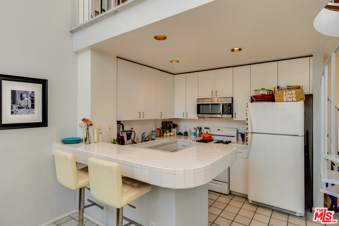 114 Fleet Street Marina del Rey, CA 90292 - Photo 5 of 19 a kitchen with sink a refrigerator and microwave