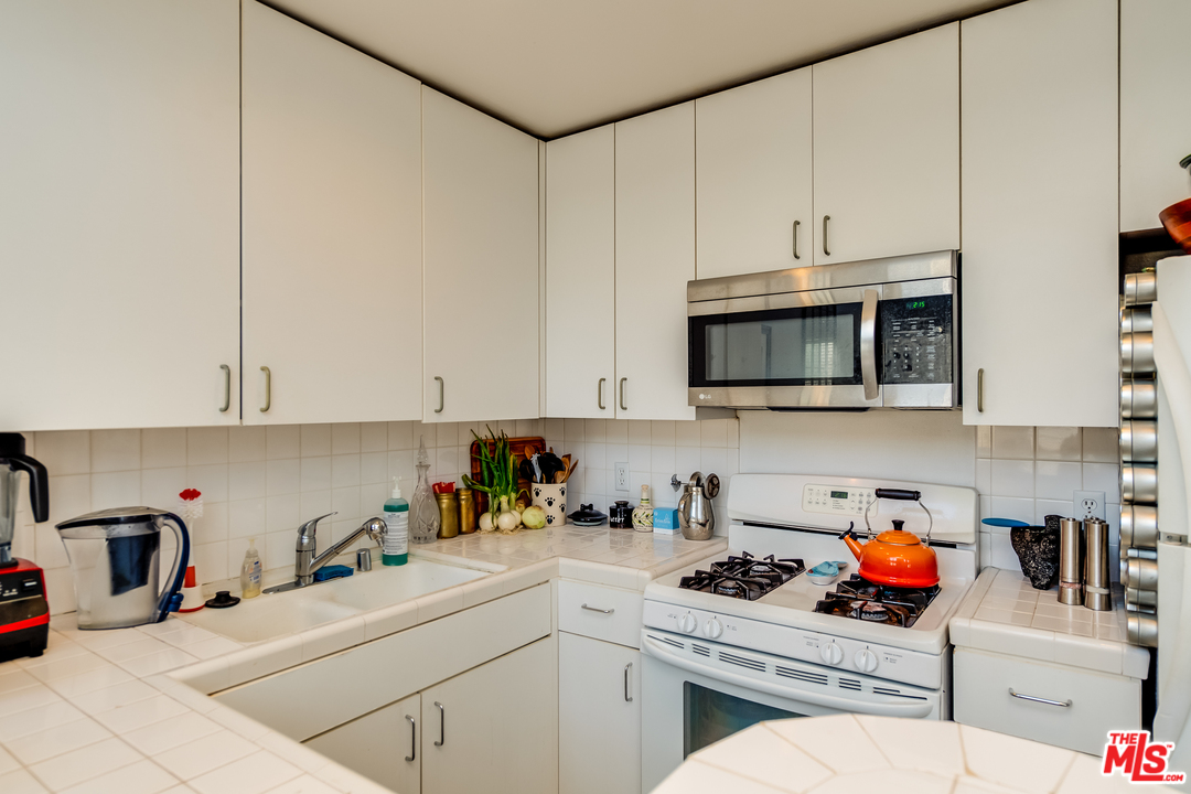 114 Fleet Street Marina del Rey, CA 90292 - Photo 6 of 19 a kitchen with stainless steel appliances granite countertop a sink a stove and cabinets
