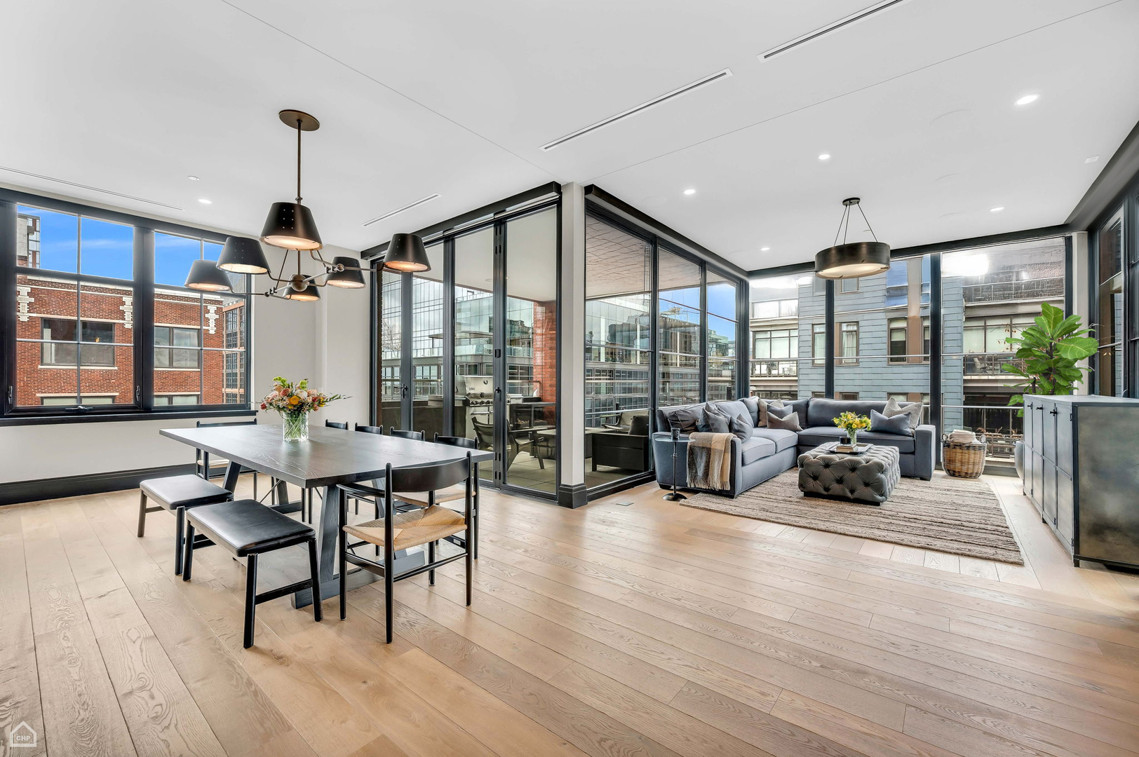1109 West Washington Boulevard, Unit 6B Chicago, IL 60607 - Photo 17 of 40 a dining room with wooden floor a chandelier a glass table and chairs