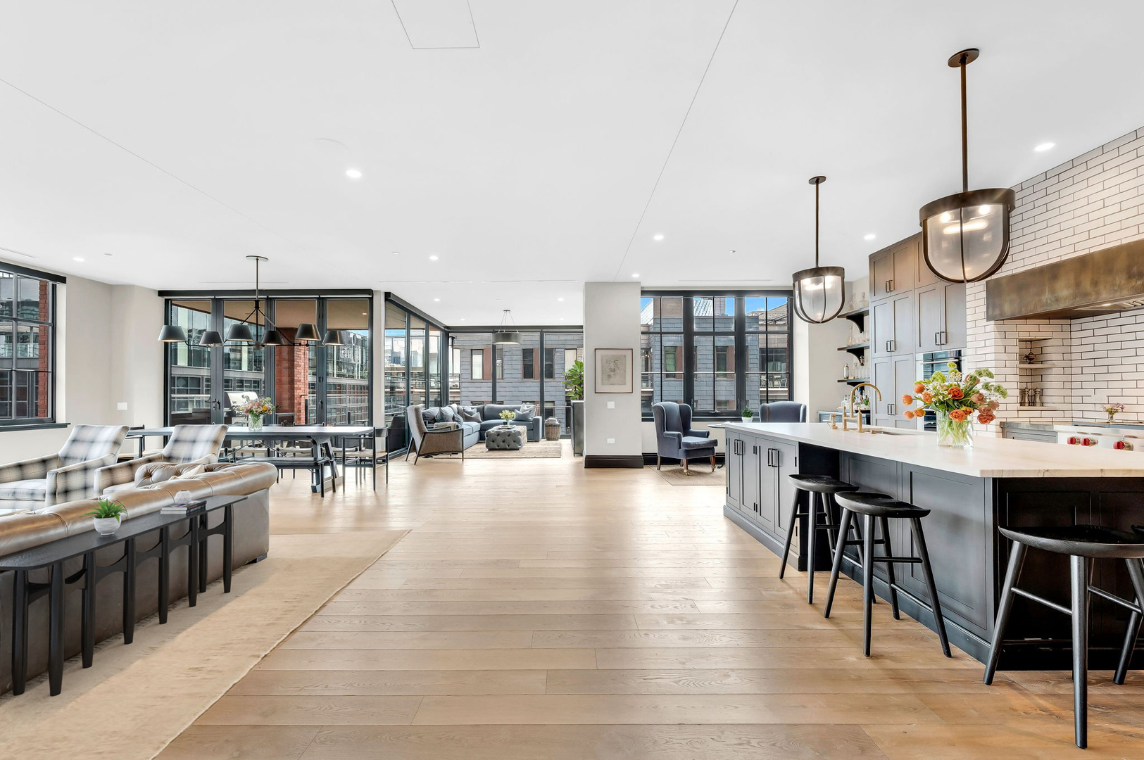 1109 West Washington Boulevard, Unit 6B Chicago, IL 60607 - Photo 2 of 40 a large kitchen with lots of counter and chairs