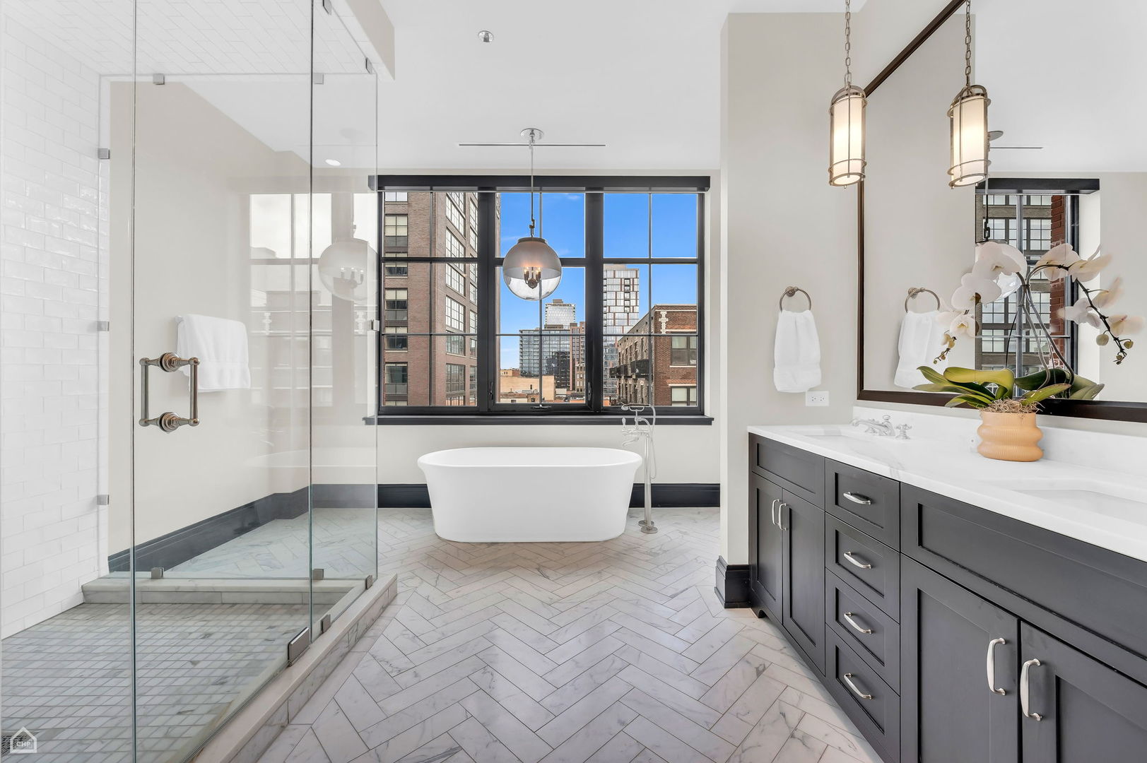 1109 West Washington Boulevard, Unit 6B Chicago, IL 60607 - Photo 24 of 40 a spacious bathroom with a double vanity sink a mirror and a bathtub