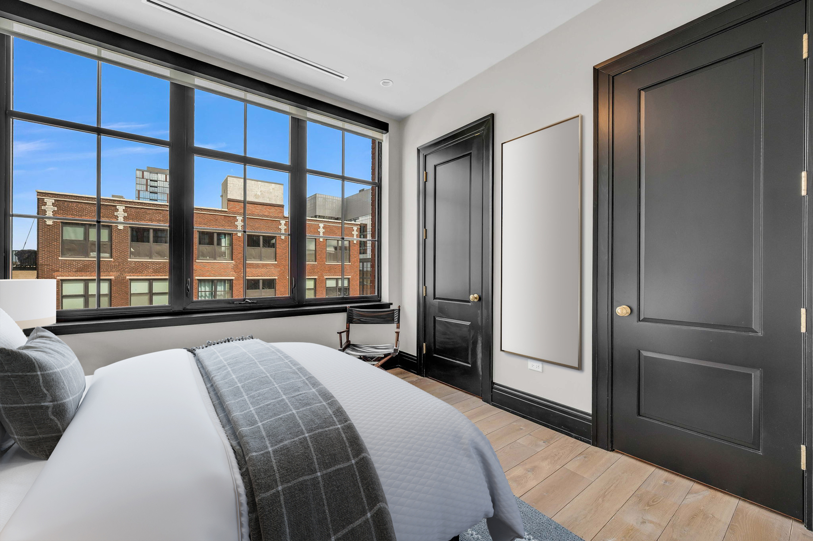 1109 West Washington Boulevard, Unit 6B Chicago, IL 60607 - Photo 31 of 40 a spacious bedroom with a large bed and a large window