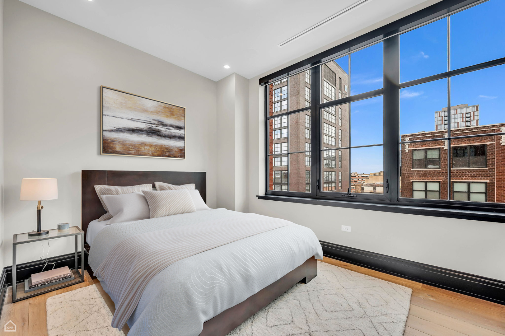 1109 West Washington Boulevard, Unit 6B Chicago, IL 60607 - Photo 33 of 40 a bedroom with a large bed and a large window