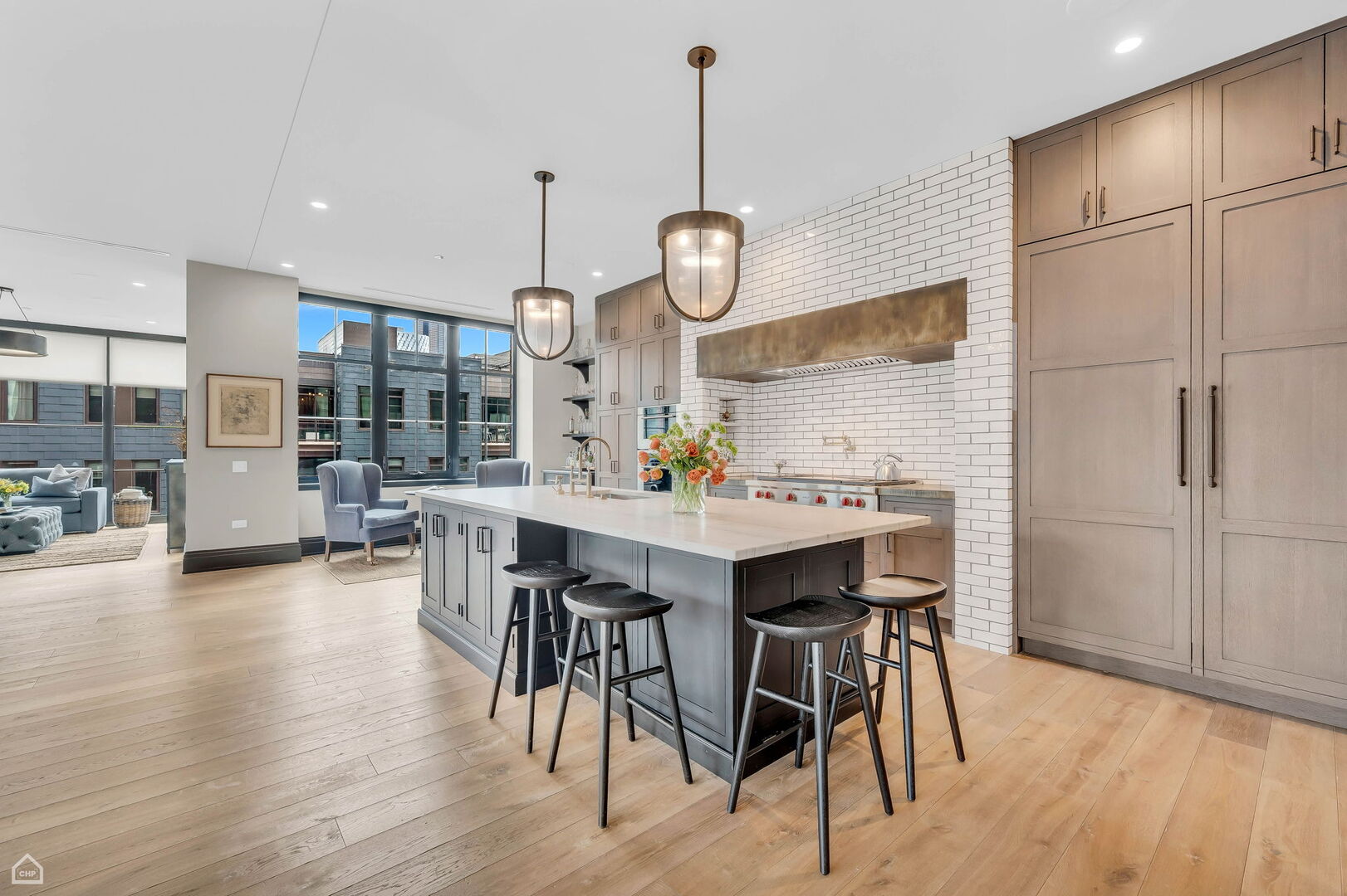 1109 West Washington Boulevard, Unit 6B Chicago, IL 60607 - Photo 7 of 40 a kitchen with stainless steel appliances kitchen island granite countertop a table chairs and a refrigerator