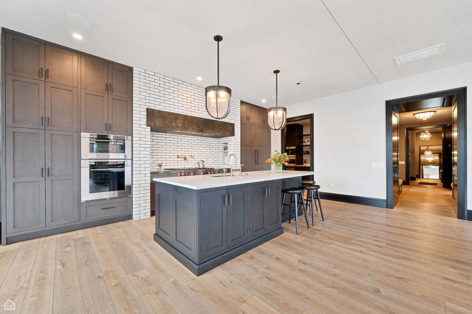 1109 West Washington Boulevard, Unit 6B Chicago, IL 60607 - Photo 8 of 40 a kitchen with kitchen island granite countertop wooden cabinets and a stove
