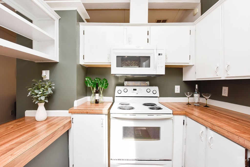 17920 Trombley Road Snohomish, WA 98290 - Photo 12 of 36 a kitchen with a stove cabinets and white appliances