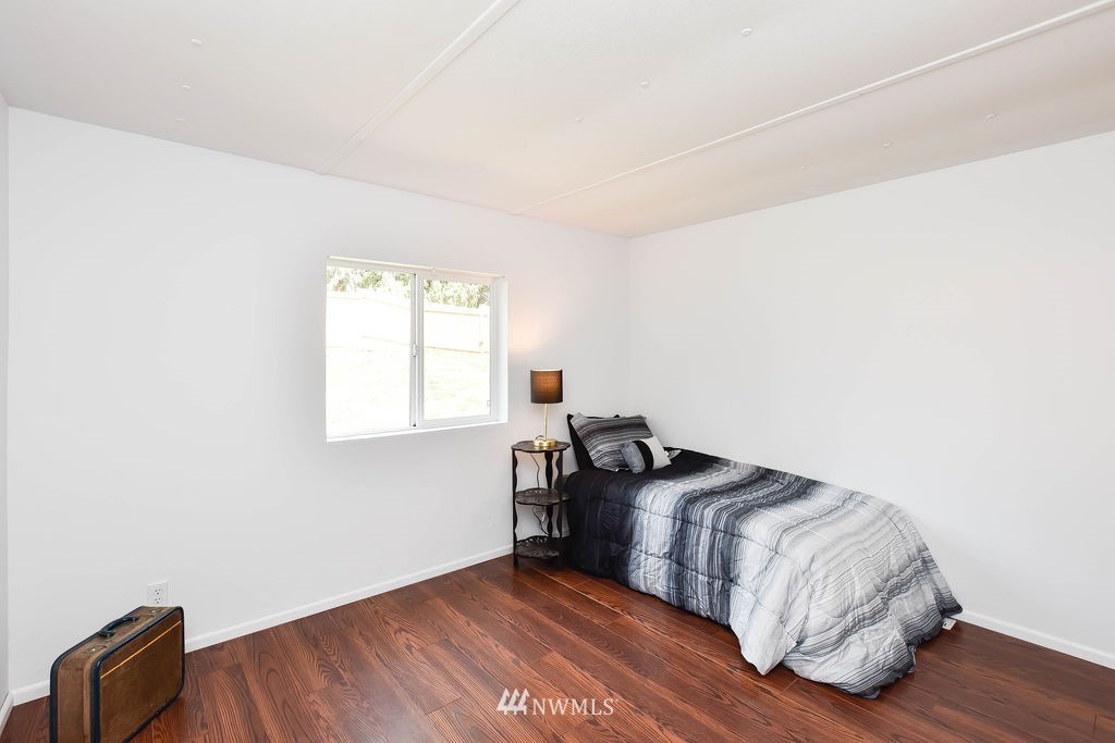 17920 Trombley Road Snohomish, WA 98290 - Photo 15 of 36 a view of a livingroom with wooden floor and bedroom