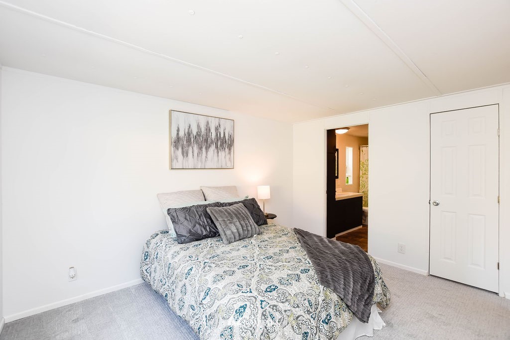 17920 Trombley Road Snohomish, WA 98290 - Photo 22 of 36 a bedroom with a bed and a painting on the wall