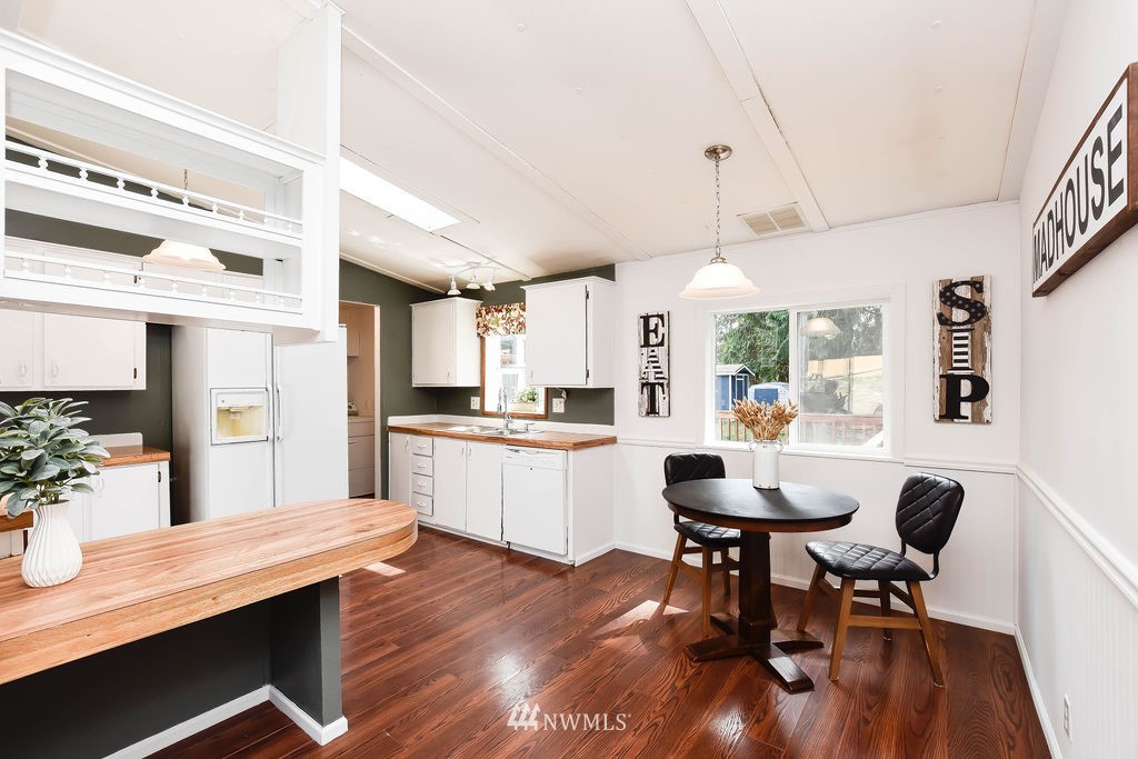17920 Trombley Road Snohomish, WA 98290 - Photo 7 of 36 a kitchen with a dining table chairs and refrigerator