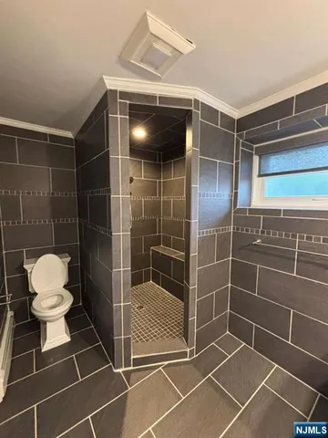 a bathroom with a toilet and a shower