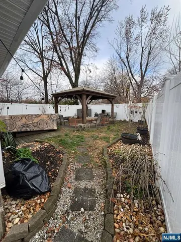 a view of a yard covered with snow in front of house