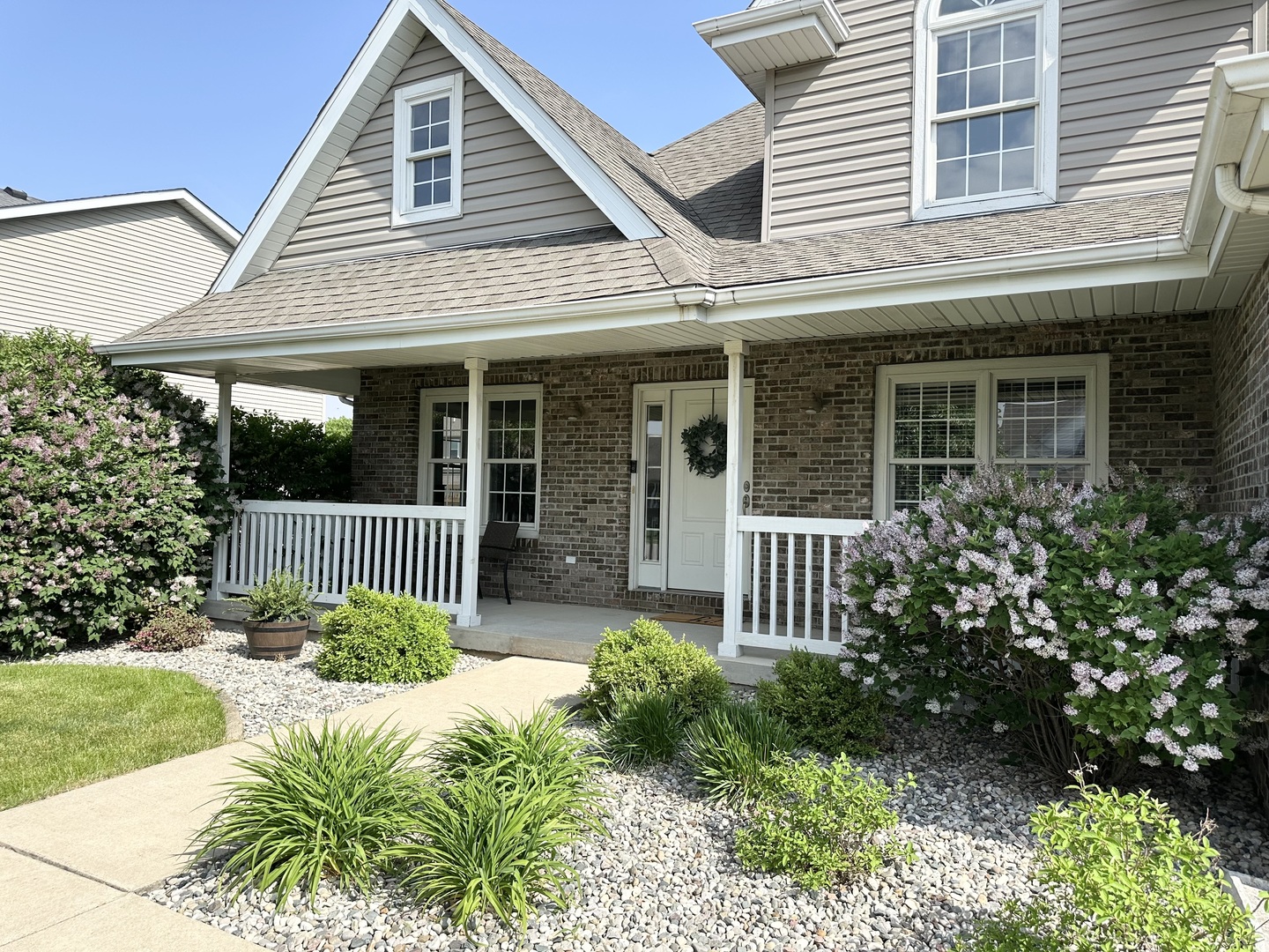 1205 Eagle Bluff Drive Bourbonnais, IL 60914 - Photo 2 of 51 a view of a house with a small yard and flower plants