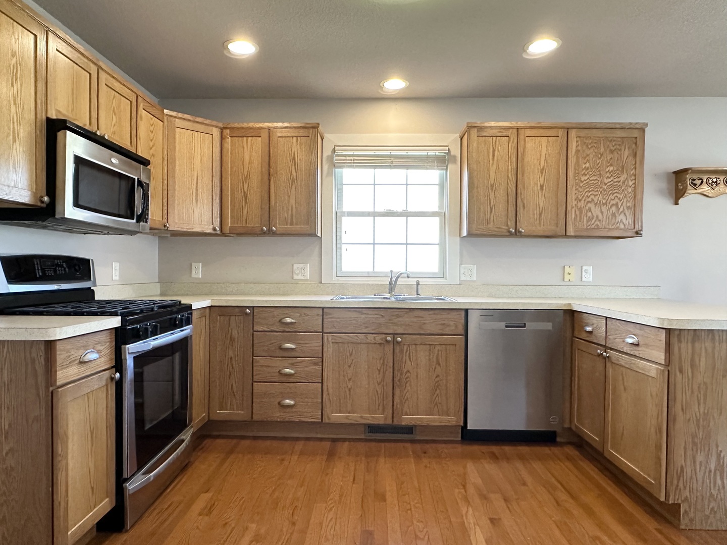 1205 Eagle Bluff Drive Bourbonnais, IL 60914 - Photo 9 of 51 a kitchen with stainless steel appliances granite countertop a stove a sink and a microwave