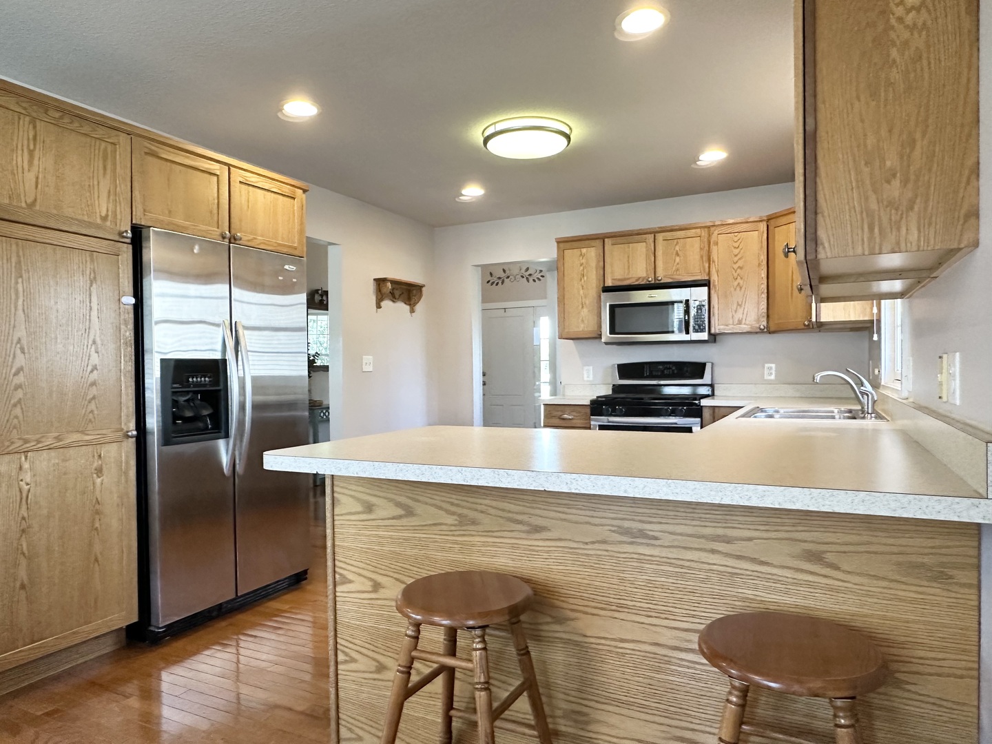 1205 Eagle Bluff Drive Bourbonnais, IL 60914 - Photo 10 of 51 a kitchen with stainless steel appliances granite countertop a sink a stove a refrigerator a microwave a counter top and cabinets