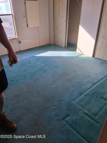 an empty room with windows and closet