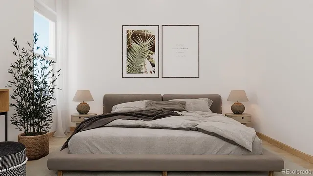 a bedroom with a bed and a potted plant