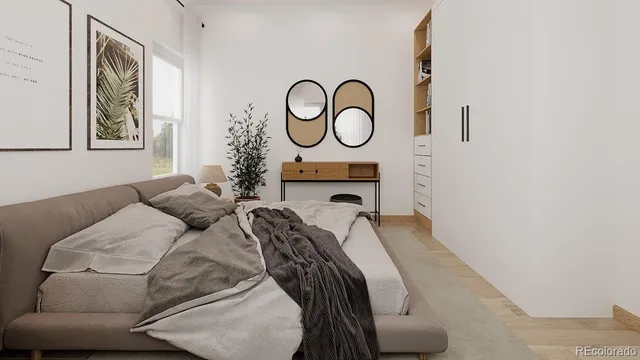 a bed room with a bed and a painting on the wall