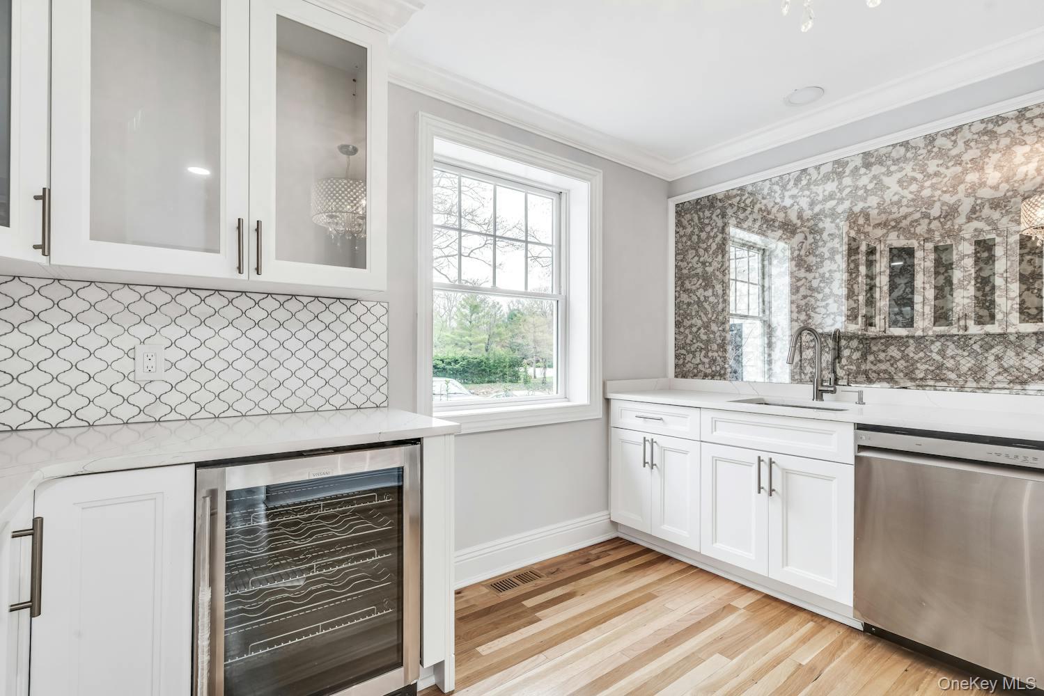 539 Split Rock Road Syosset, NY 11791 - Photo 18 of 40 Bar with ornamental molding, wine cooler, dishwasher, a sink, and backsplash