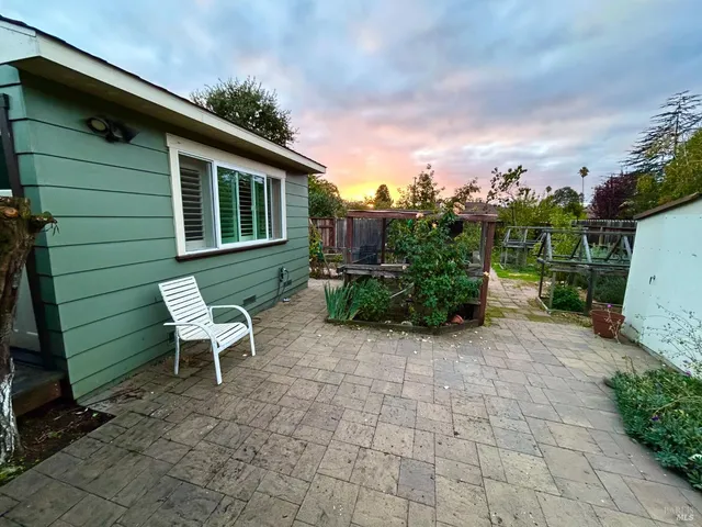 a backyard of a house with outdoor seating