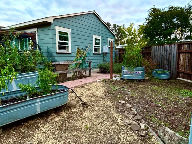 a view of a house with backyard and sitting area