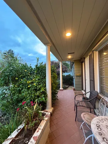 a living room with patio furniture and garden