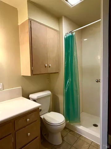 a bathroom with a toilet a sink and shower