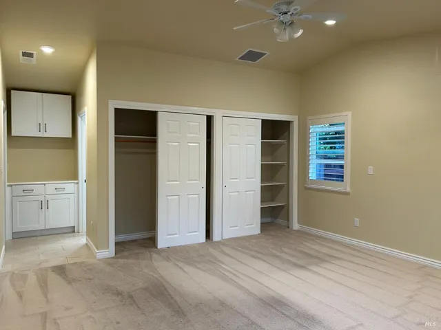 an empty room with a kitchen and a sink