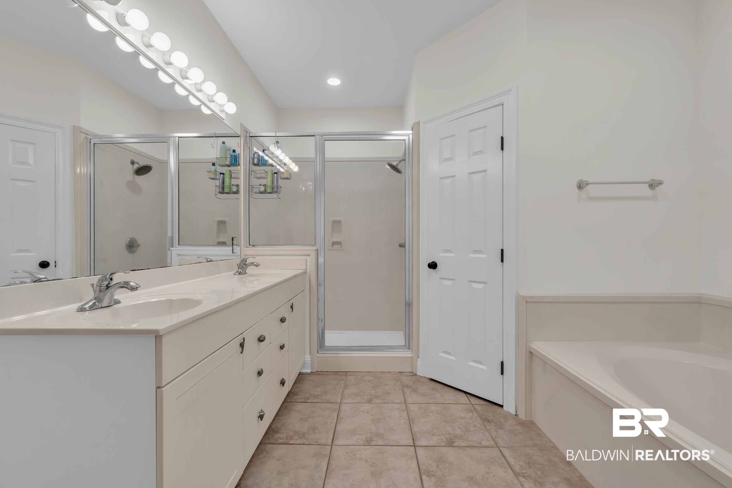 4606 Osprey Drive Orange Beach, AL 36561 - Photo 29 of 44 Full bathroom with a shower stall, double vanity, a garden tub, and tile patterned flooring, his and hers closet