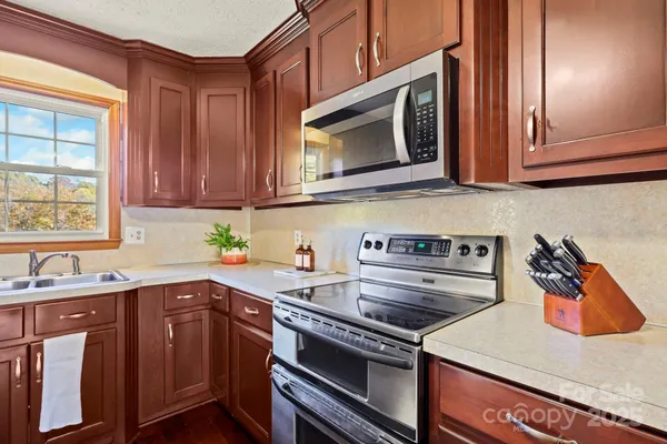 a kitchen with a stove microwave and sink