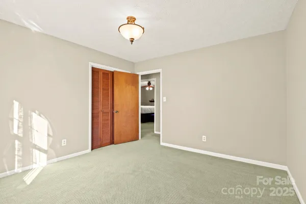 a bedroom with a bed dresser and a window