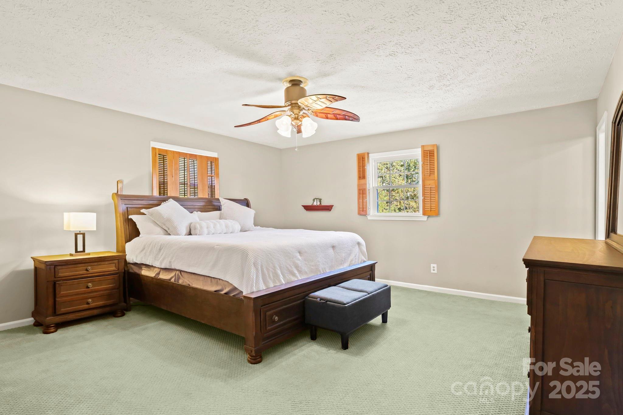 2216 Olde Well Road Hudson, NC 28638 - Photo 21 of 48 a spacious bedroom with a bed and a chandelier