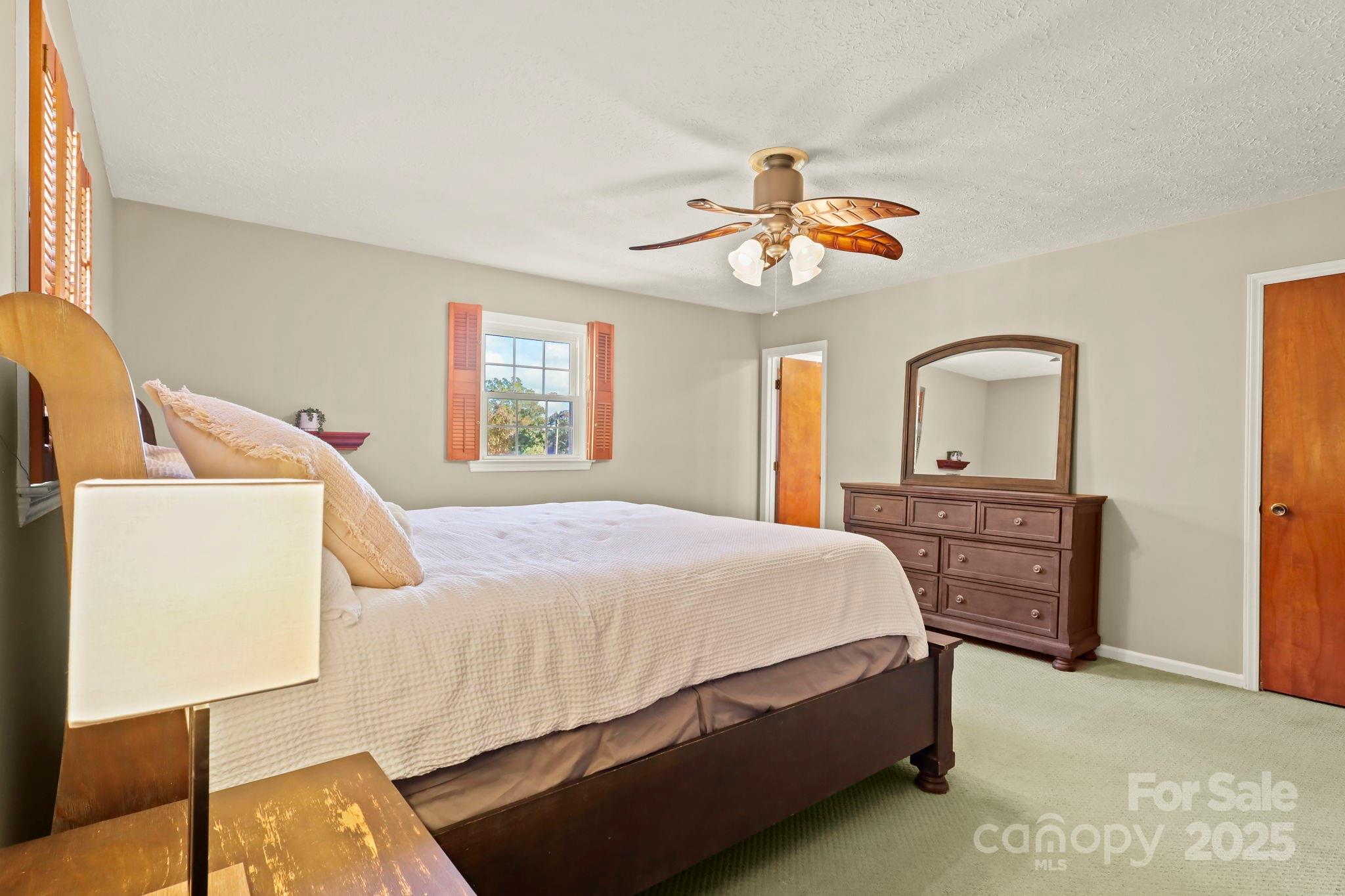 2216 Olde Well Road Hudson, NC 28638 - Photo 22 of 48 a bedroom with a bed and a chandelier
