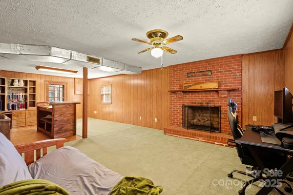 a living room with a large window and furniture