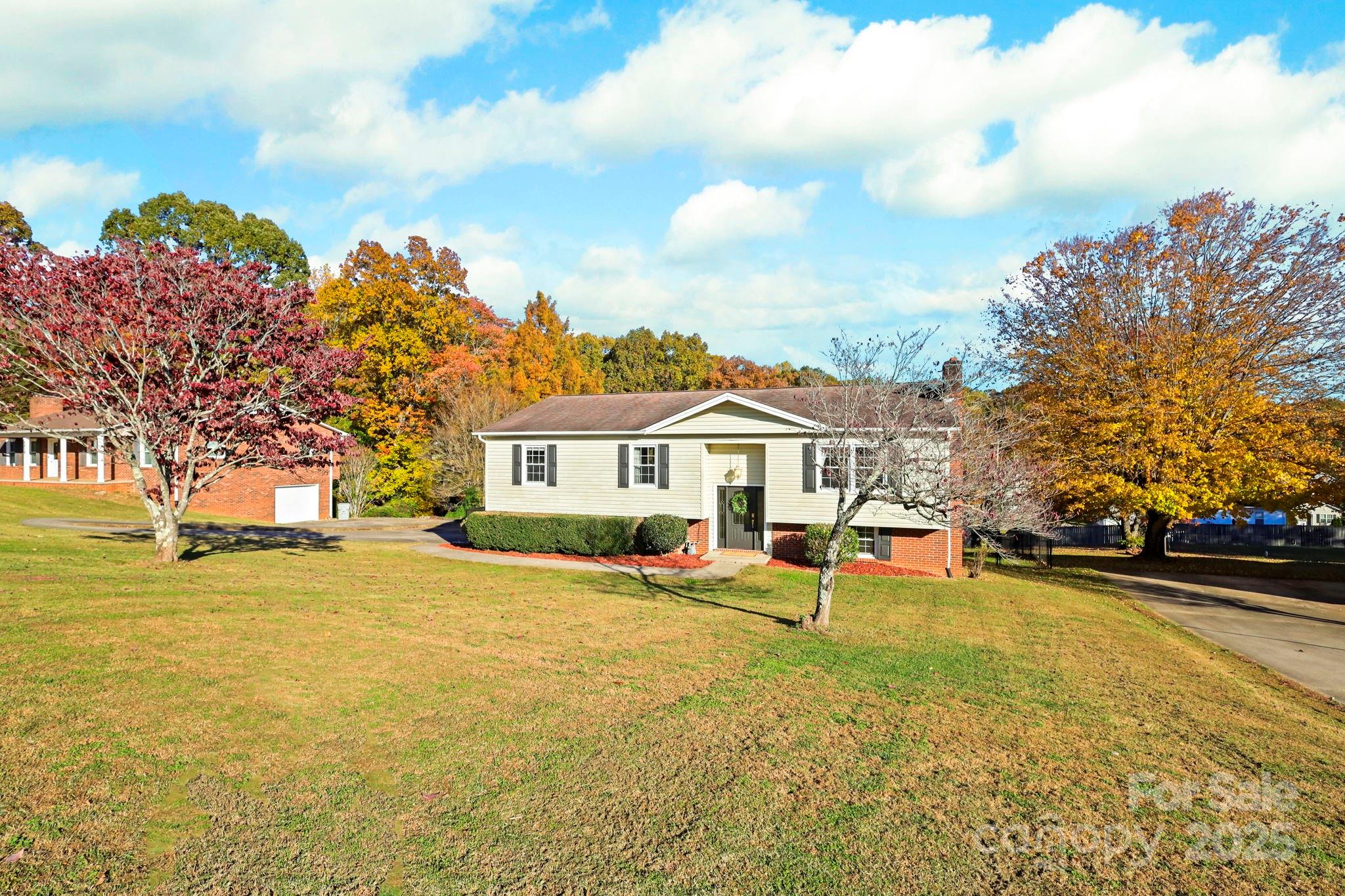 2216 Olde Well Road Hudson, NC 28638 - Photo 3 of 48 a view of a white house with a big yard and large trees
