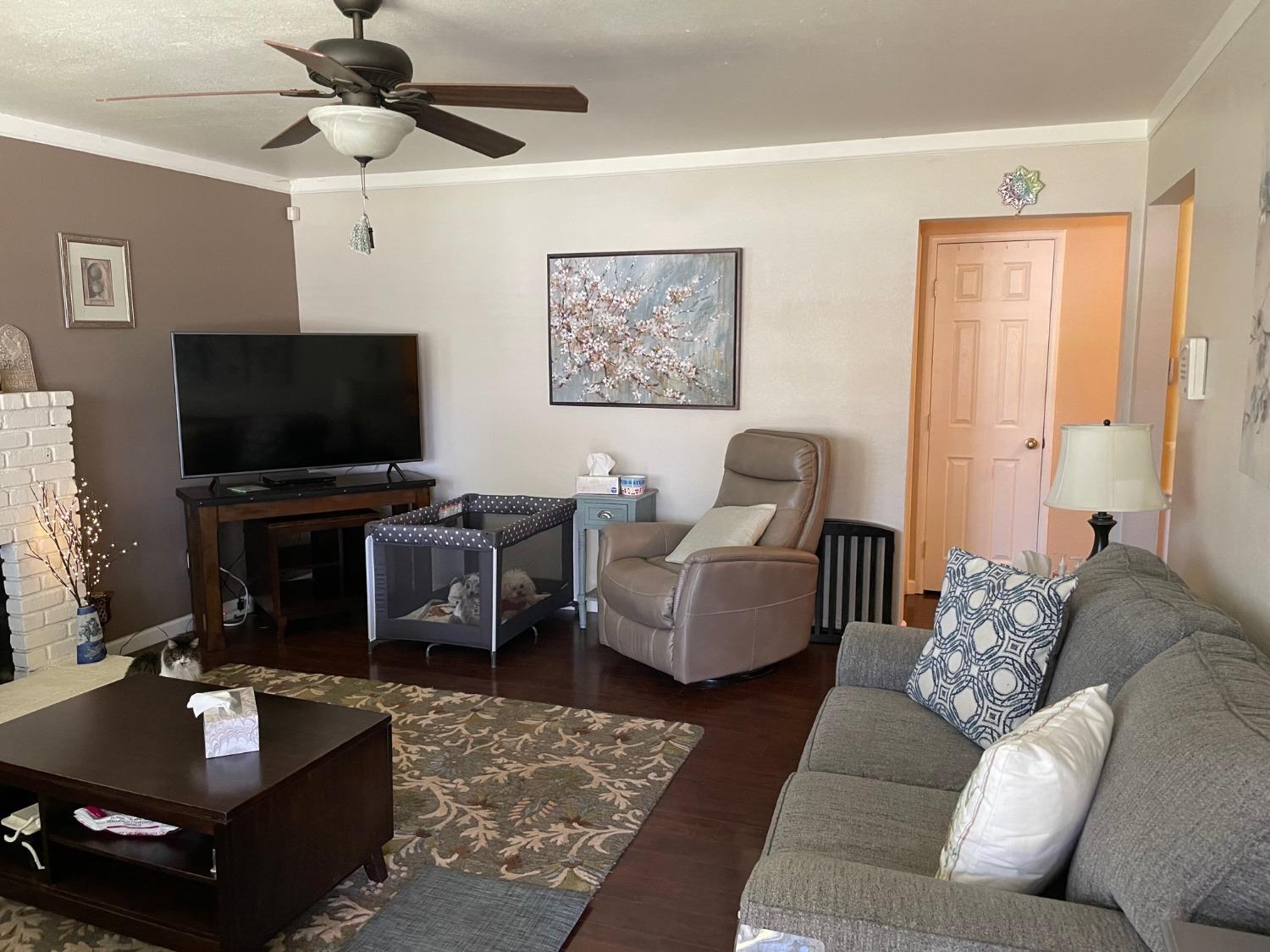 1606 Bay Meadows Drive Modesto, CA 95350 - Photo 3 of 20 a living room with furniture and a flat screen tv