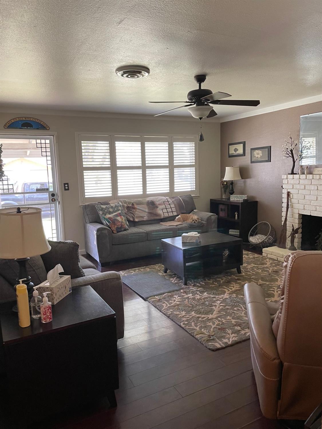 1606 Bay Meadows Drive Modesto, CA 95350 - Photo 4 of 20 a living room with furniture a chandelier and a window
