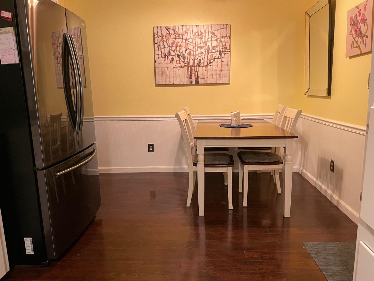 1606 Bay Meadows Drive Modesto, CA 95350 - Photo 6 of 20 a kitchen with stainless steel appliances wooden floor and a refrigerator
