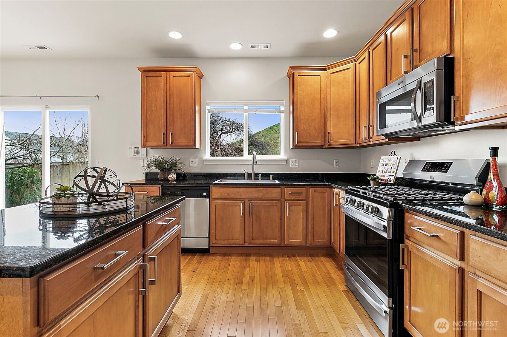 27729 257th Avenue Southeast Maple Valley, WA 98038 - Photo 11 of 40 a kitchen with stainless steel appliances granite countertop a stove a sink and a microwave