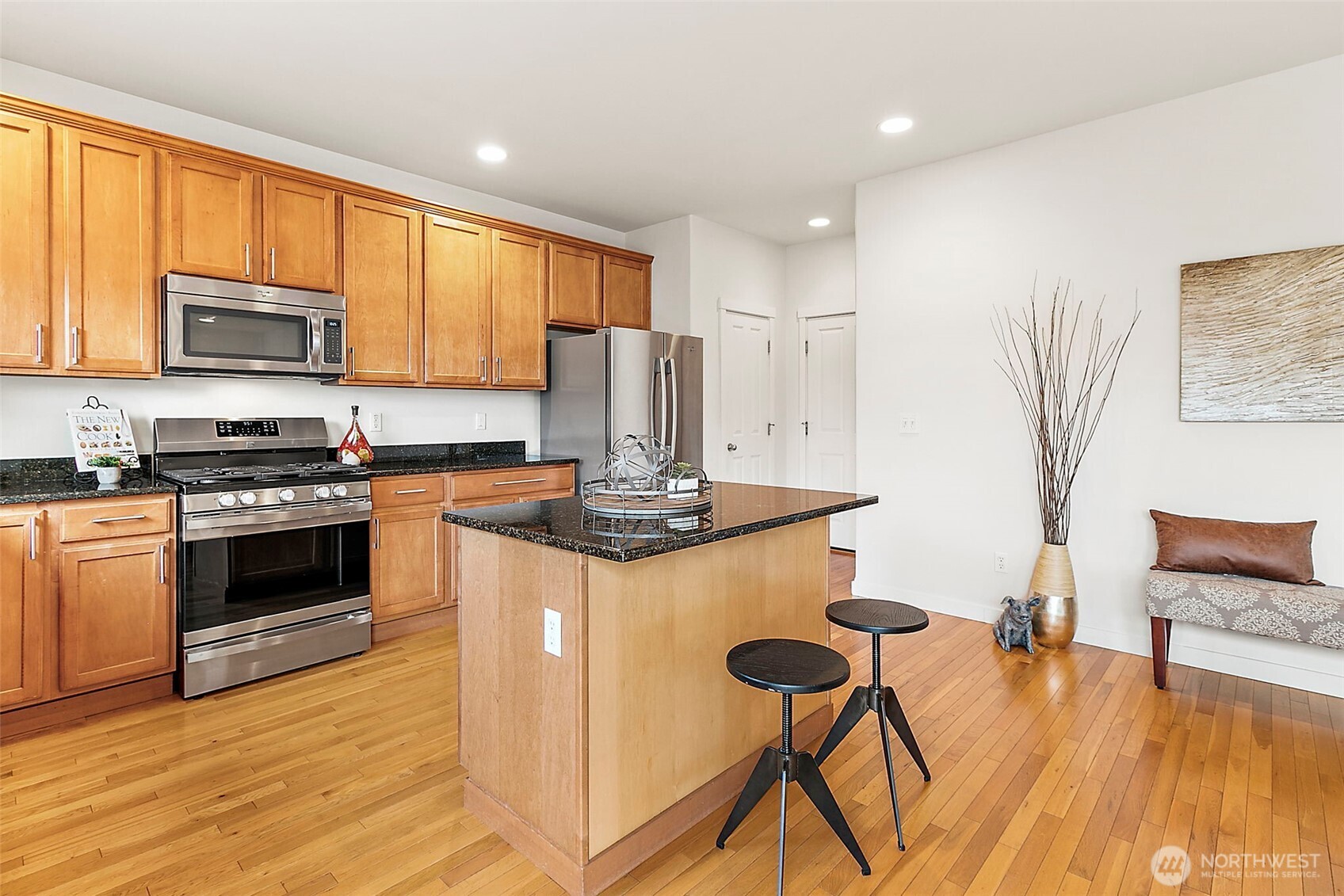 27729 257th Avenue Southeast Maple Valley, WA 98038 - Photo 14 of 40 a kitchen with stainless steel appliances a stove a sink a microwave a refrigerator and cabinets