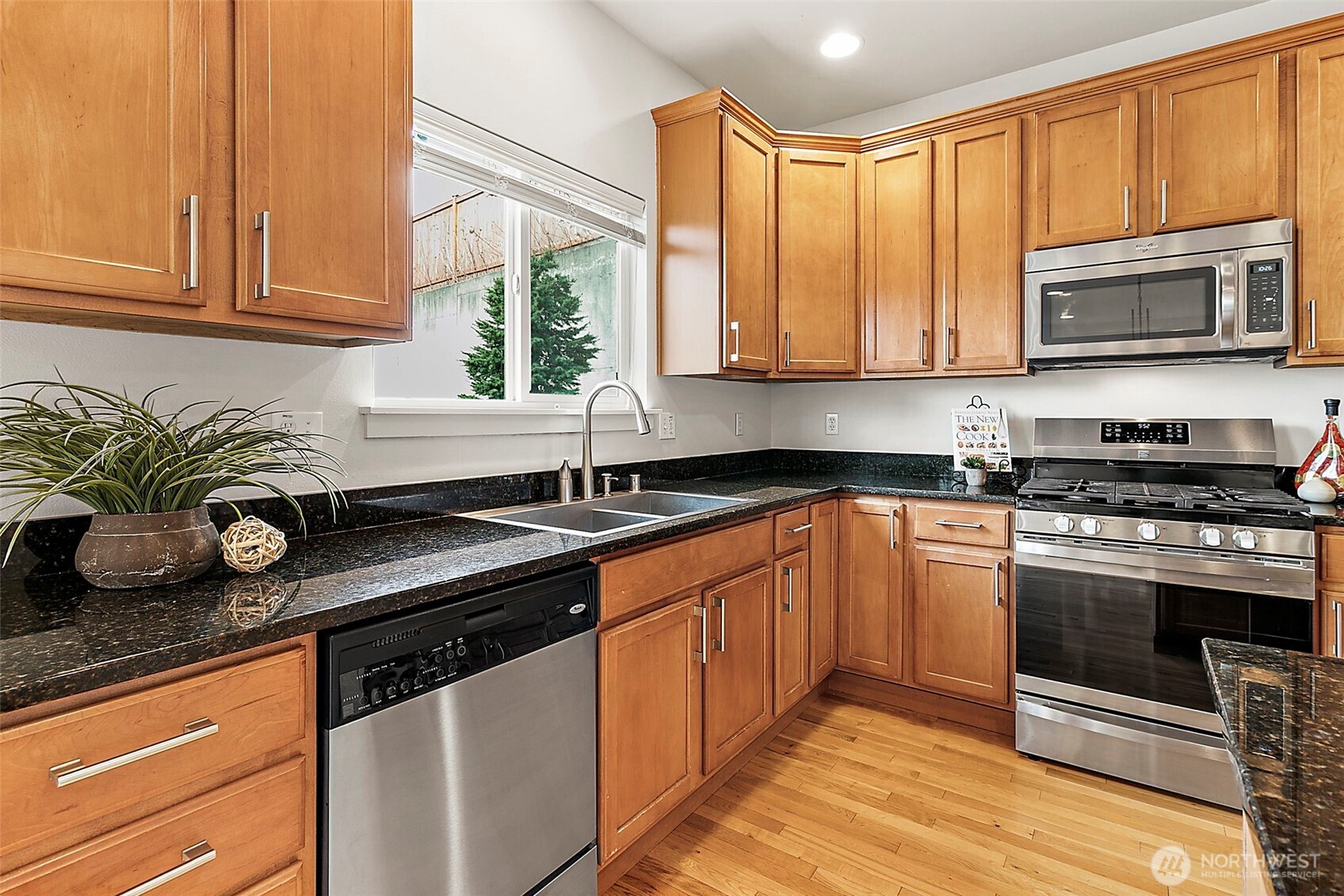 27729 257th Avenue Southeast Maple Valley, WA 98038 - Photo 15 of 40 a kitchen with stainless steel appliances granite countertop a sink a stove and cabinets
