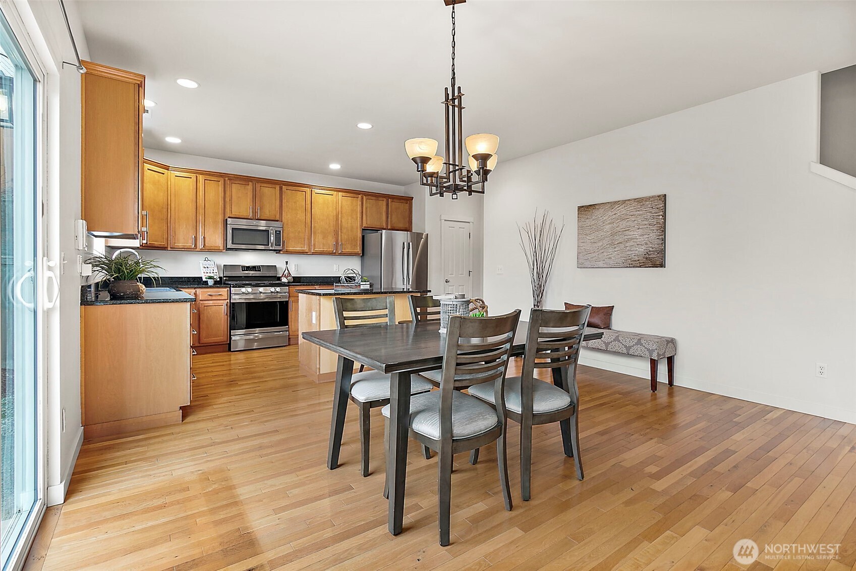 27729 257th Avenue Southeast Maple Valley, WA 98038 - Photo 2 of 40 a view of a dining room with furniture window and wooden floor