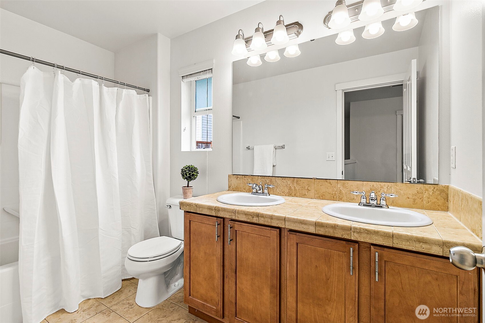 27729 257th Avenue Southeast Maple Valley, WA 98038 - Photo 22 of 40 a bathroom with a sink a toilet and mirror