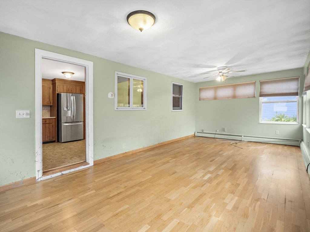 11 Dane Street Peabody, MA 01960 - Photo 16 of 27 an empty room with wooden floor and windows