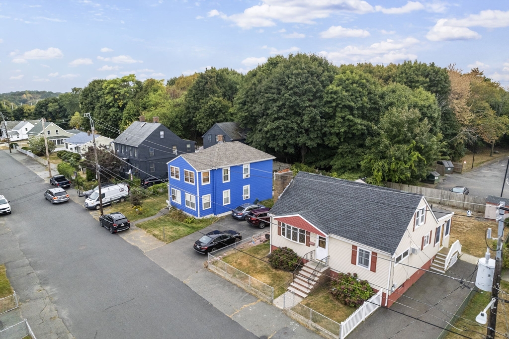 11 Dane Street Peabody, MA 01960 - Photo 26 of 27 an aerial view of a house with swimming pool and trees in the background