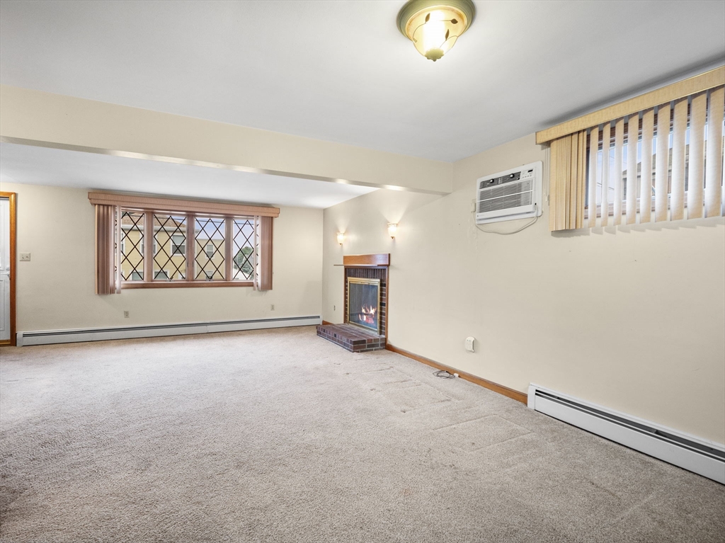 11 Dane Street Peabody, MA 01960 - Photo 5 of 27 an empty room with windows and fireplace