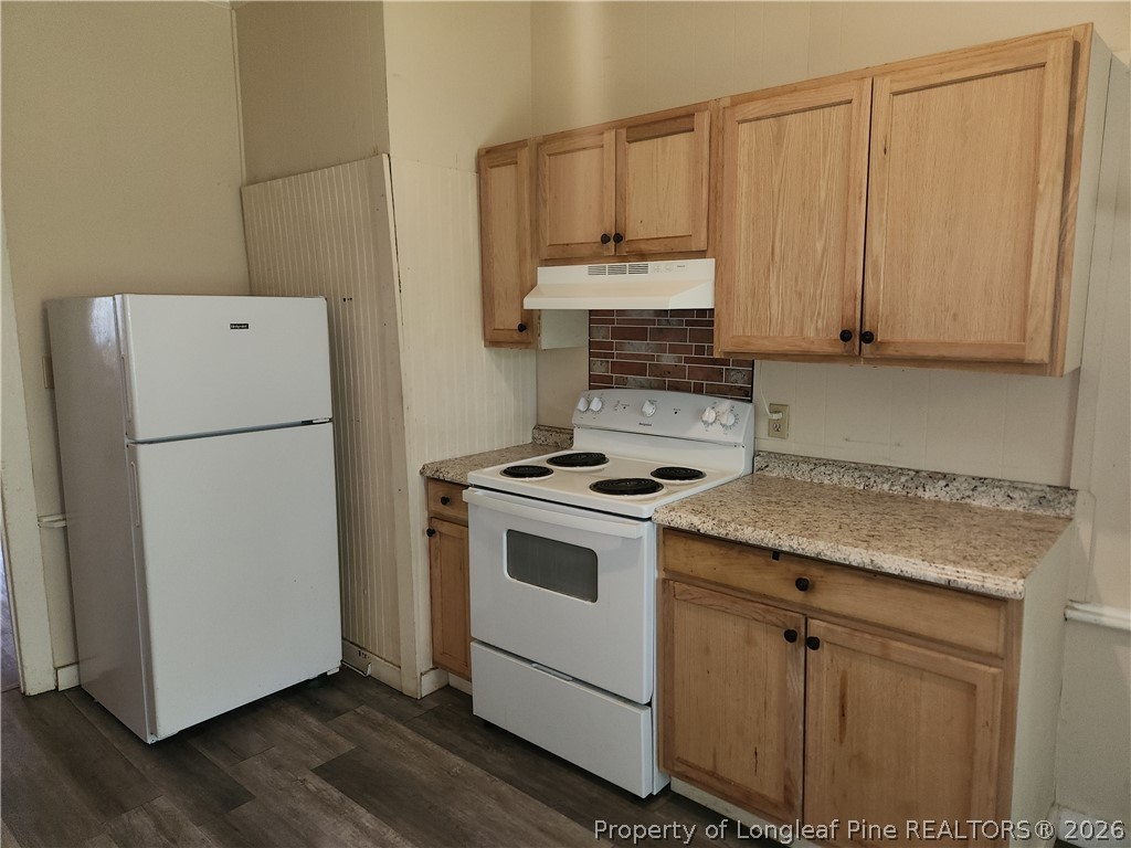 3939 Ellison Street Hope Mills, NC 28348 - Photo 6 of 7 a kitchen with a white cabinets and white appliances