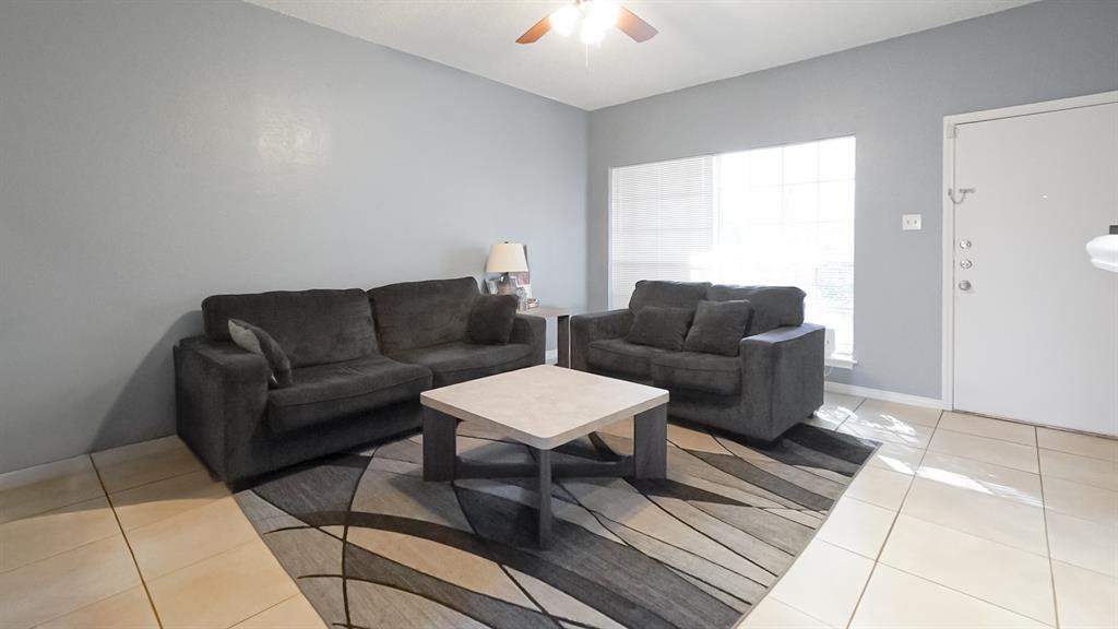 12921 Abrams Road, Unit 505 Dallas, TX 75243 - Photo 8 of 24 Living area with light tile patterned floors and a ceiling fan