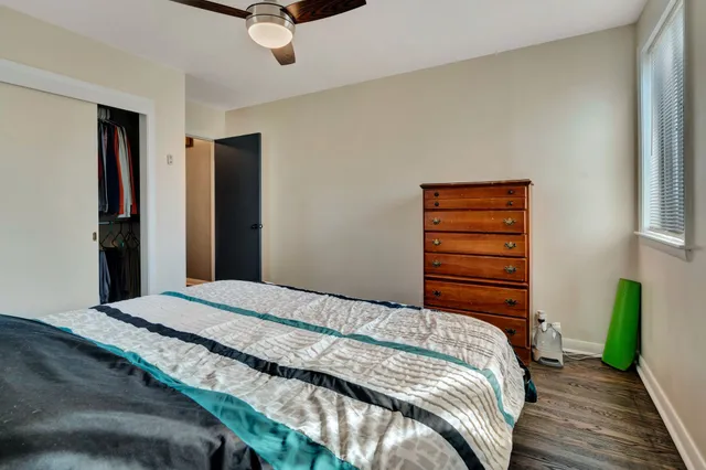 a bedroom with a bed and a ceiling fan